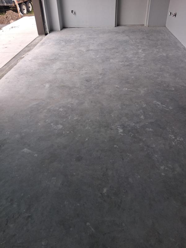Bare grey concrete garage floor before coating